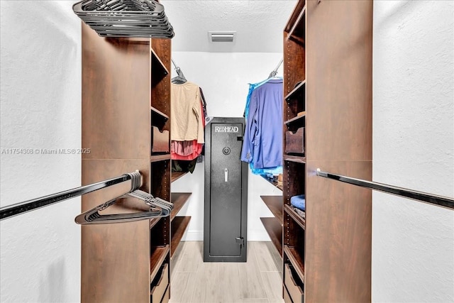 walk in closet featuring visible vents and wood finished floors