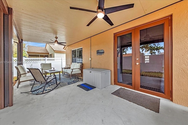 view of patio / terrace with ceiling fan, fence, and french doors