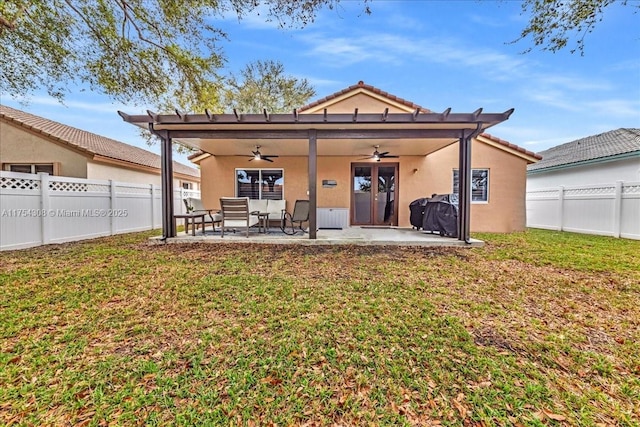 back of property featuring a fenced backyard, ceiling fan, a patio, and a lawn