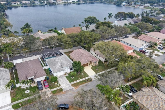 drone / aerial view with a water view and a residential view