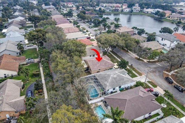 drone / aerial view featuring a water view and a residential view