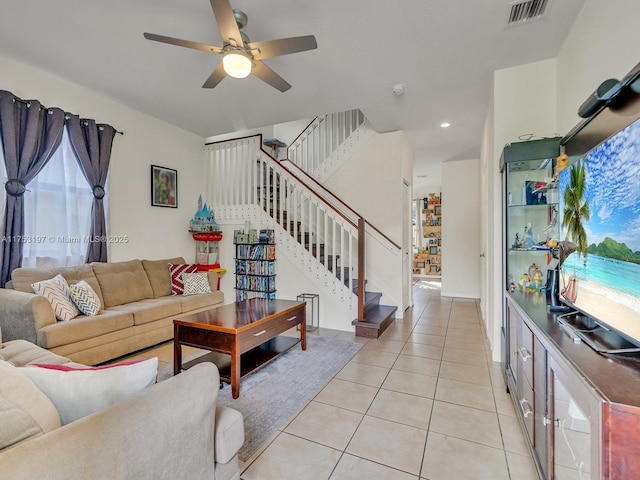 living room featuring light tile patterned floors, recessed lighting, visible vents, a ceiling fan, and stairs