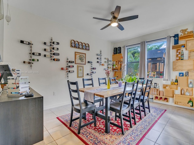 dining space featuring baseboards, a ceiling fan, and light tile patterned flooring