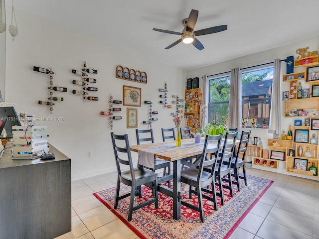 dining room featuring light tile patterned floors, baseboards, and a ceiling fan