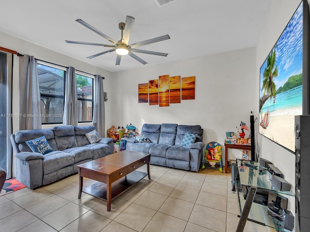 living area with light tile patterned floors, visible vents, and a ceiling fan