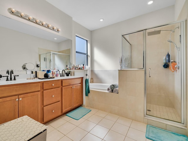 bathroom with double vanity, tile patterned floors, a sink, and a shower stall