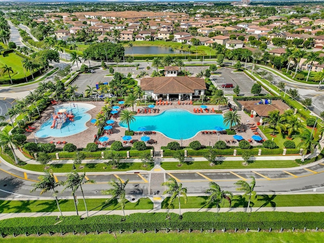 drone / aerial view with a water view and a residential view