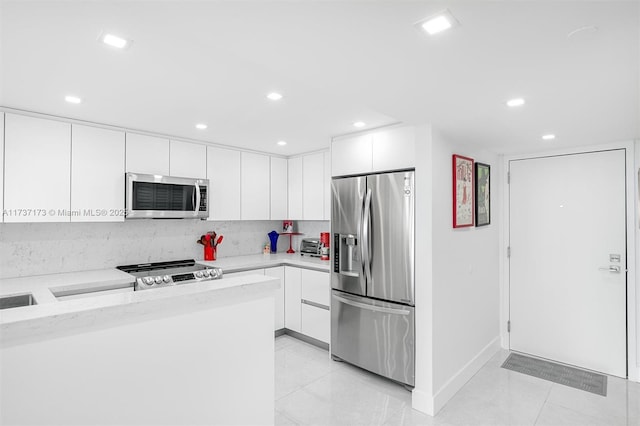 kitchen with stainless steel appliances, recessed lighting, white cabinetry, and light tile patterned floors