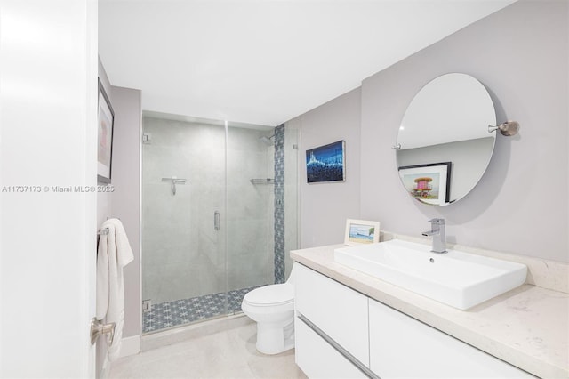 bathroom with a stall shower, vanity, and toilet