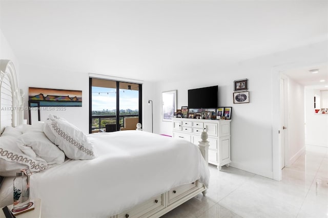 bedroom with a wall of windows and access to outside