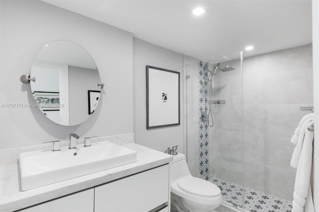 full bath with toilet, a stall shower, vanity, and recessed lighting