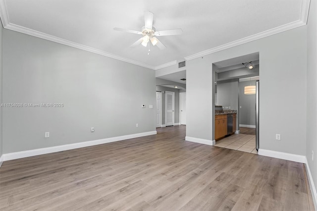 unfurnished living room featuring crown molding, visible vents, light wood-style floors, ceiling fan, and baseboards