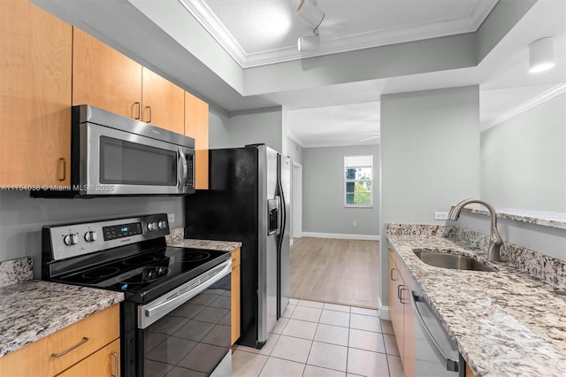 kitchen with light tile patterned floors, appliances with stainless steel finishes, a sink, and ornamental molding