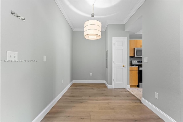 unfurnished dining area with light wood finished floors, baseboards, and crown molding