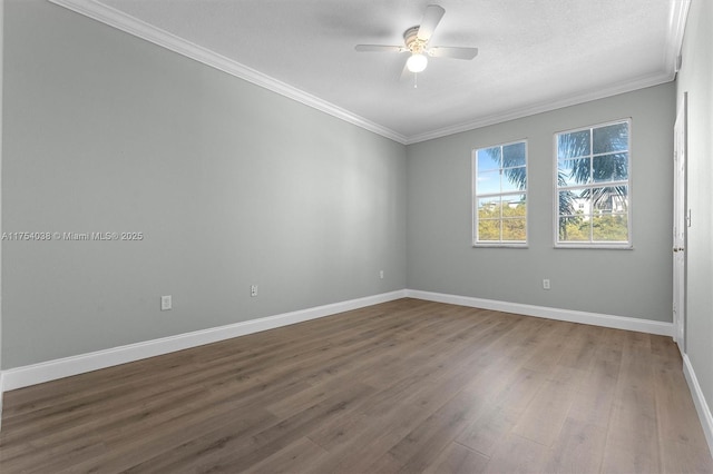 empty room with baseboards, a ceiling fan, and crown molding