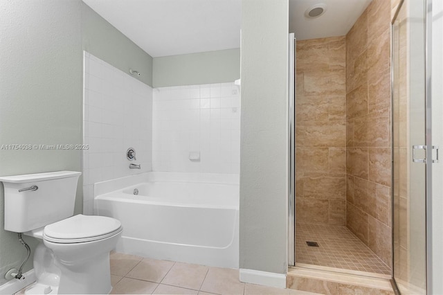 full bath featuring toilet, a tub, a tile shower, and tile patterned floors