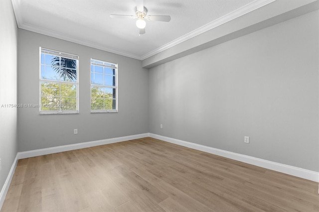 unfurnished room with ornamental molding, ceiling fan, light wood-style floors, and baseboards