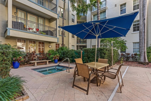 view of swimming pool with a patio and a hot tub