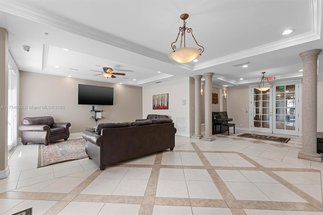 living area featuring a tray ceiling, crown molding, recessed lighting, ornate columns, and baseboards