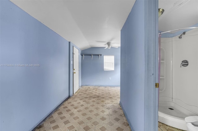 bathroom featuring lofted ceiling, a shower stall, ceiling fan, and tile patterned floors