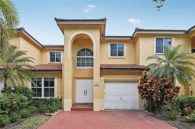 view of front of property featuring a garage and stucco siding