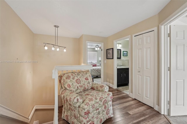 living area with baseboards and wood finished floors