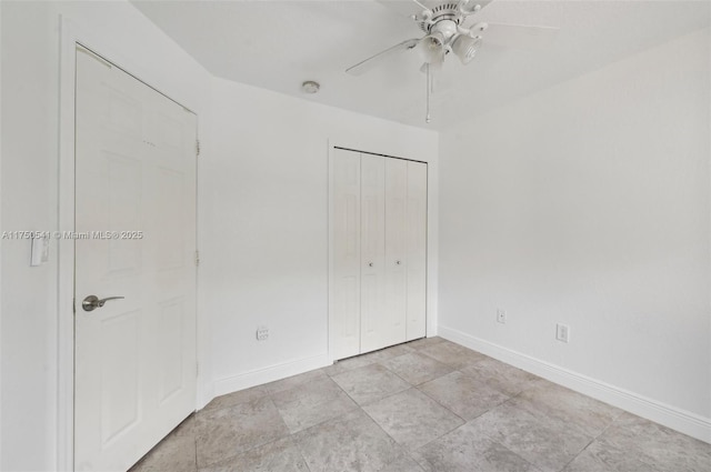 unfurnished bedroom with ceiling fan, baseboards, and a closet