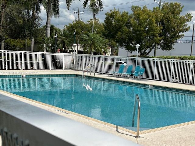 community pool featuring fence