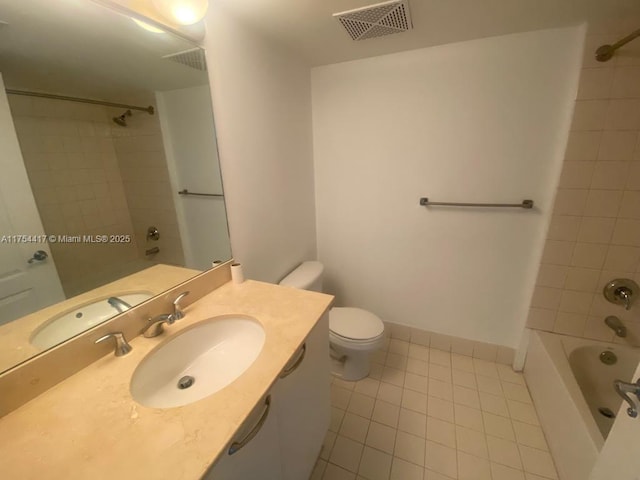 bathroom with visible vents, toilet, vanity,  shower combination, and tile patterned flooring