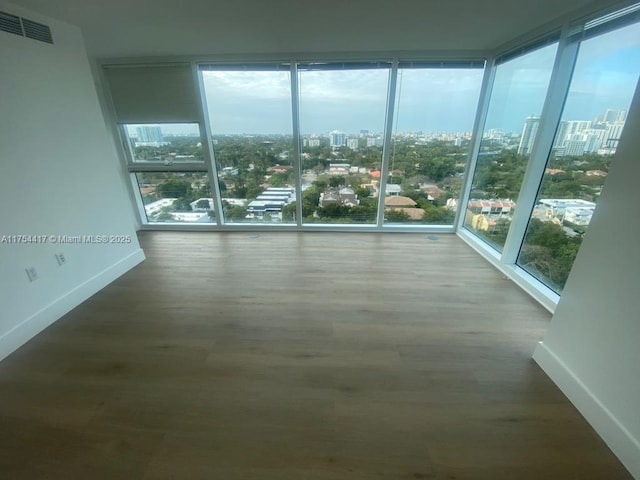 unfurnished sunroom featuring visible vents and a city view