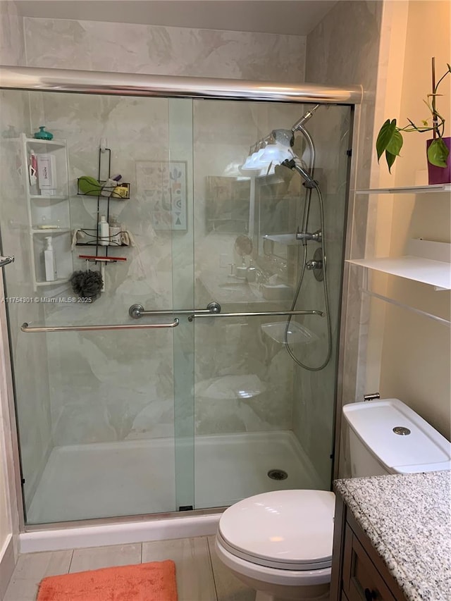 full bathroom with toilet, a shower stall, and vanity