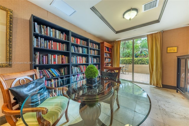 sitting room featuring stone tile floors and visible vents