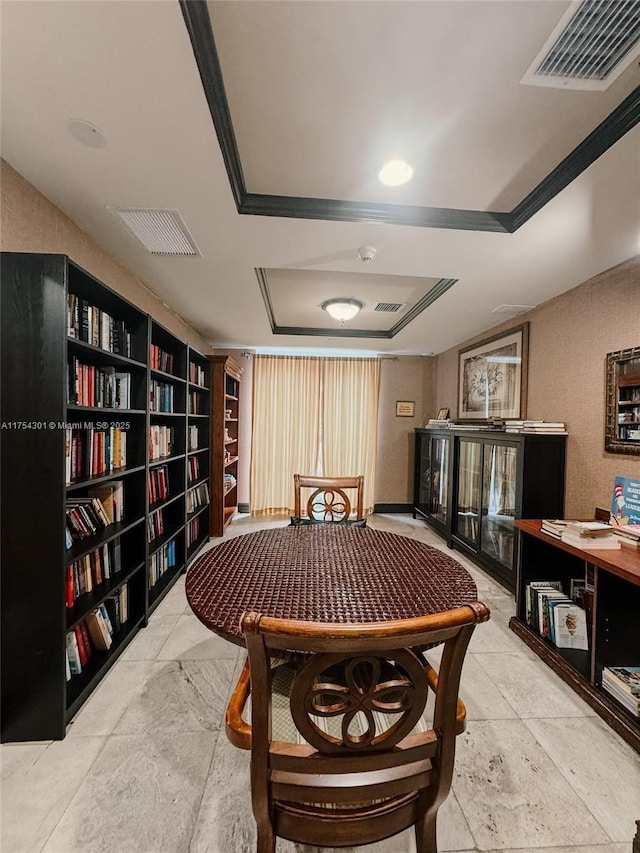 interior space with a tray ceiling and visible vents