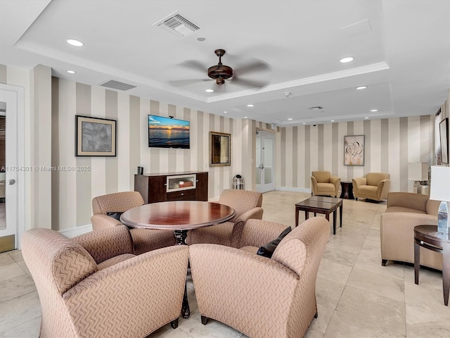 living room featuring wallpapered walls, visible vents, a tray ceiling, and recessed lighting