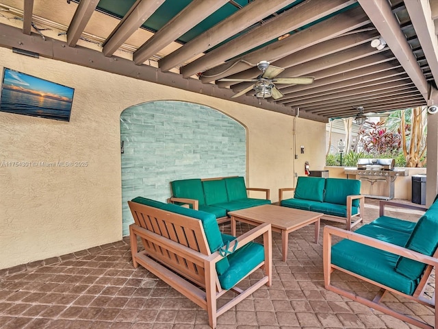 view of patio / terrace with ceiling fan, an outdoor living space, and exterior kitchen