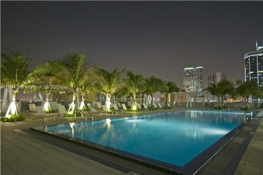 pool at night with a community pool