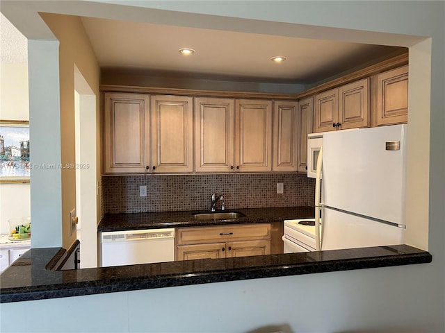 kitchen featuring white appliances, tasteful backsplash, a sink, and recessed lighting