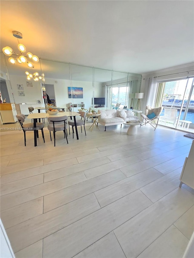 2600 Diana Dr Unit 103, Hallandale Beach, FL 33009 - living area with healthy amount of natural light and a chandelier