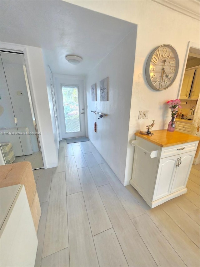 hallway with baseboards and wood tiled floor