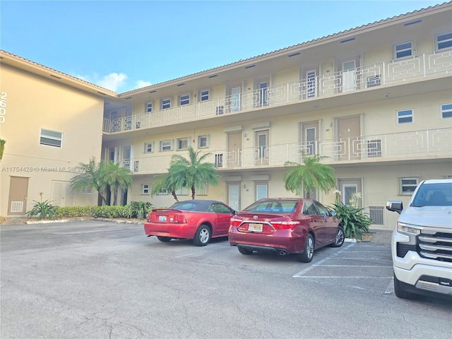 view of building exterior featuring uncovered parking