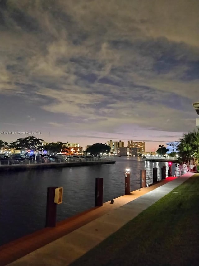 view of dock with a view of city and a water view