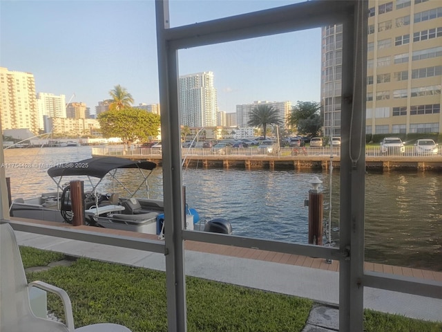 water view featuring nearby urban area and a dock