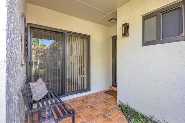 entrance to property with stucco siding