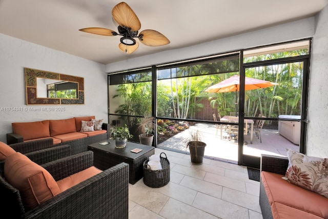 living area with a textured wall and ceiling fan