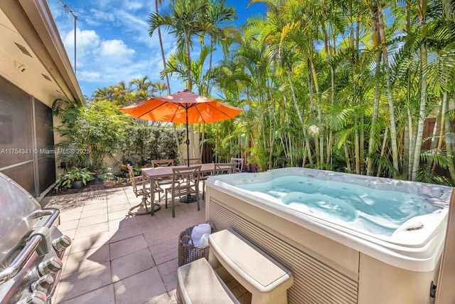 view of patio featuring outdoor dining space and a hot tub