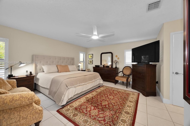 bedroom featuring multiple windows, visible vents, and light tile patterned flooring