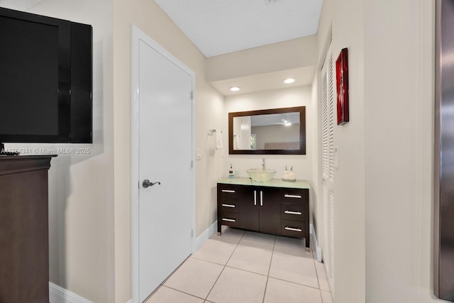 bathroom with recessed lighting, tile patterned flooring, baseboards, and vanity