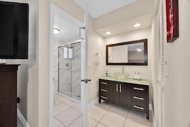 full bath with recessed lighting, vanity, a shower stall, baseboards, and tile patterned floors