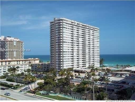 view of building exterior with a view of city and a water view