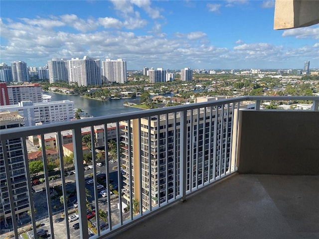 balcony featuring a view of city and a water view